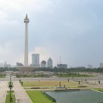 Merdeka Square view from Gambir Station upper platform. Jakarta's landmark Monas (National Monument) towering the square as the centerpiece, with reflecting pool and Kartini memorial on East Medan Merdeka park. Central Jakarta, Indonesia.
