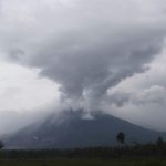Mount Semeru releases volcanic materials during an eruption as seen from Lumajang district, East Java province, Indonesia, Monday, Dec. 6, 2021. The death toll from eruption of the highest volcano on Indonesia's most densely populated island of Java has risen with scores still missing, officials said Sunday as rain continued to pound the region and hamper the search.(AP Photo/Trisnadi)